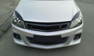 Накладки на передні фари Opel Astra H фото