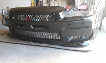 Бампер передний Mitsubishi Lancer X в стиле EVO фото