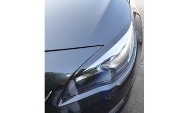 Накладки на передние фары Opel Astra J фото